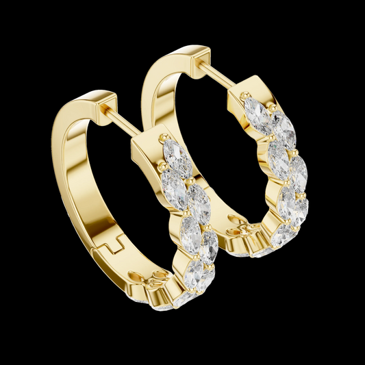 Gold hoop earrings with clear gemstones on a white background