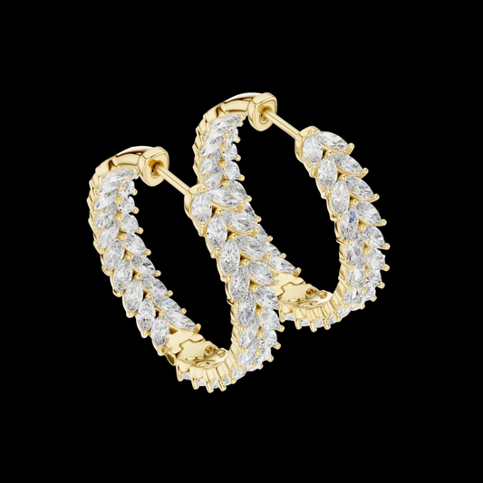 Gold hoop earrings with clear gemstones on a black background