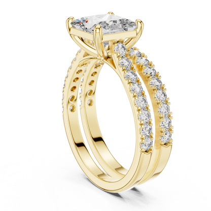 Gold ring with a large diamond and smaller diamonds on the band against a white background