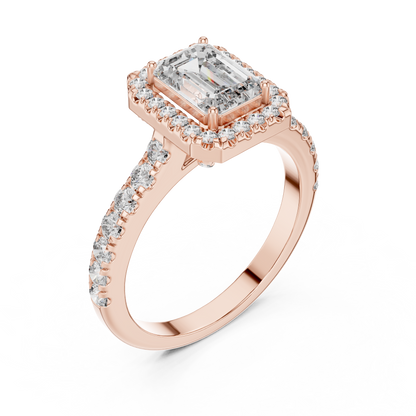 Rose gold ring with emerald-cut diamond and smaller diamonds on a white background